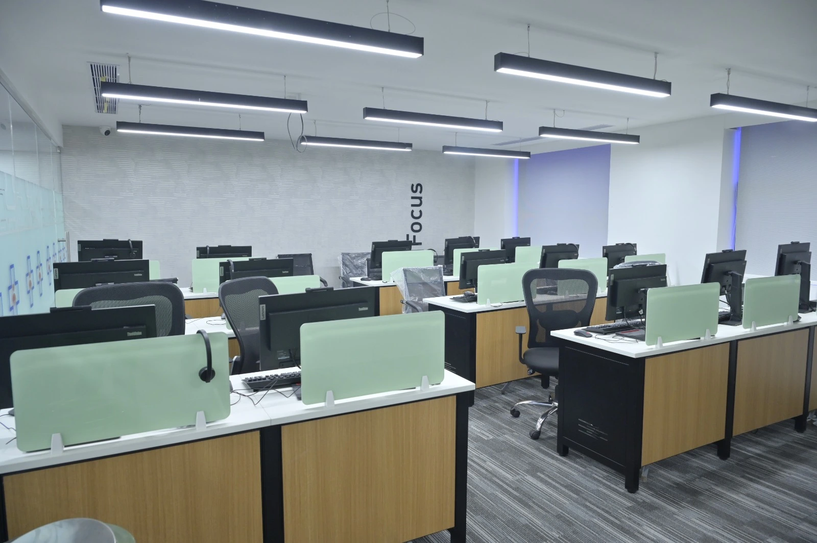 Startup office interior with modular workstations and glass cabins in Chennai office design
