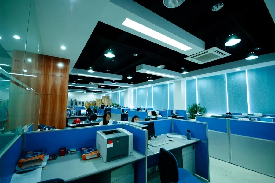 Open-plan IT office workstations with modern ambient lighting