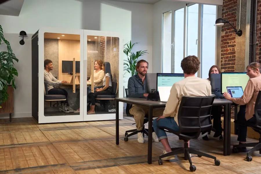 Employees collaborating around a shared table in a modern open office