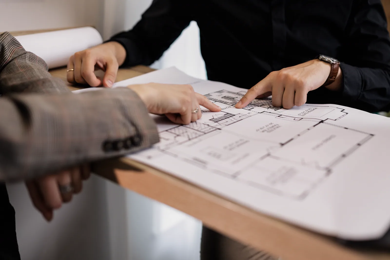 Orange Interior design team reviewing floor plans and material samples